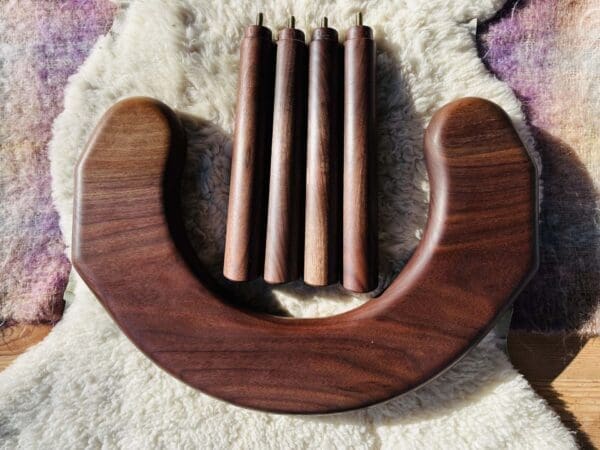 Half moon, u-shaped stool. Disassembled. Showing the topside with 4 stool legs placed nearby.